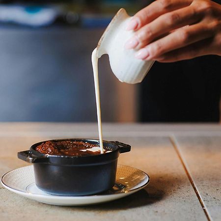 Stock Exchange Hotel, Manchester, Autograph Collection Εξωτερικό φωτογραφία A pot of chocolate pudding being topped with cream